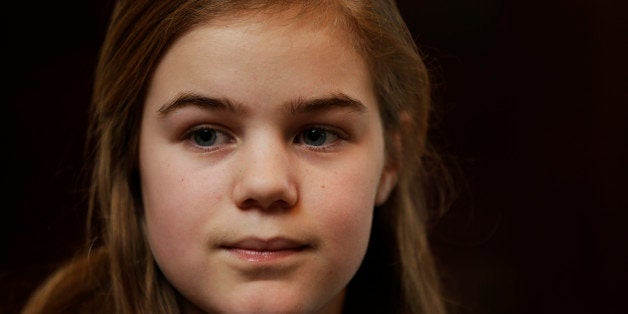 Caroline Pla, 11, listens to a question during an interview Thursday, Feb. 21, 2013, in Doylestown, Pa. Pla is fighting the Roman Catholic Archdiocese of Philadelphia for the right to continue playing church sponsored youth football. (AP Photo/Matt Rourke)