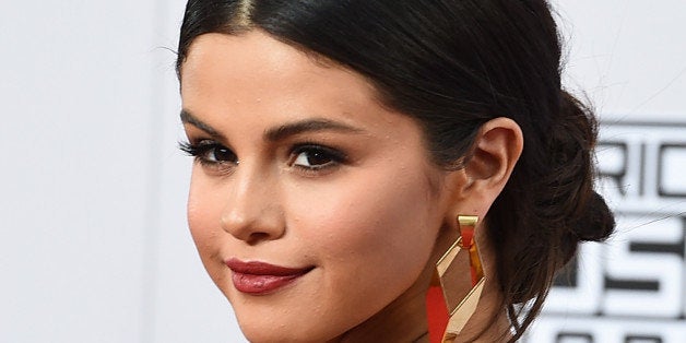 Selena Gomez arrives at the 42nd annual American Music Awards at Nokia Theatre L.A. Live on Sunday, Nov. 23, 2014, in Los Angeles. (Photo by Jordan Strauss/Invision/AP)