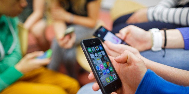 GOETTINGEN, GERMANY - SEPTEMBER 19: Posed scene: group of students playing with their smartphones at the Georg-Christoph-Lichtenberg-Gesamtschule IGS Goettingen on September 19, 2014, in Goettingen, Germany. The Georg-Christoph-Lichtenberg-Gesamtschule is a comprehensive school. Photo by Thomas Trutschel/Photothek via Getty Images)***Local Caption***