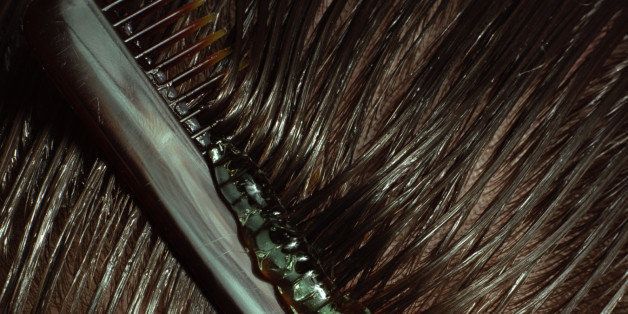 Man combing gel through hair, close-up