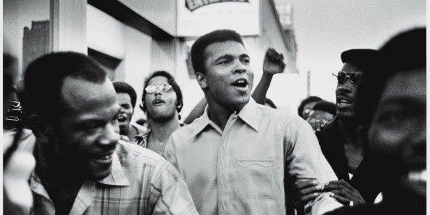 American heavyweight boxing champion Muhammad Ali walks through the streets with members of the Black Panther Party, New York