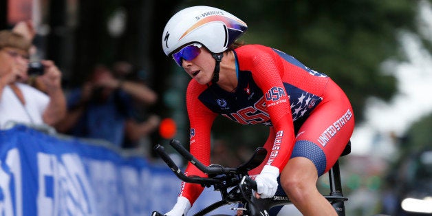 Evelyn Stevens, of the US is cheered on by fans as she rounds a curve during the Women's Elite Time Trials for the UCI Road World Championships in Richmond, Va., Tuesday, Sept. 22, 2015. (AP Photo/Steve Helber)