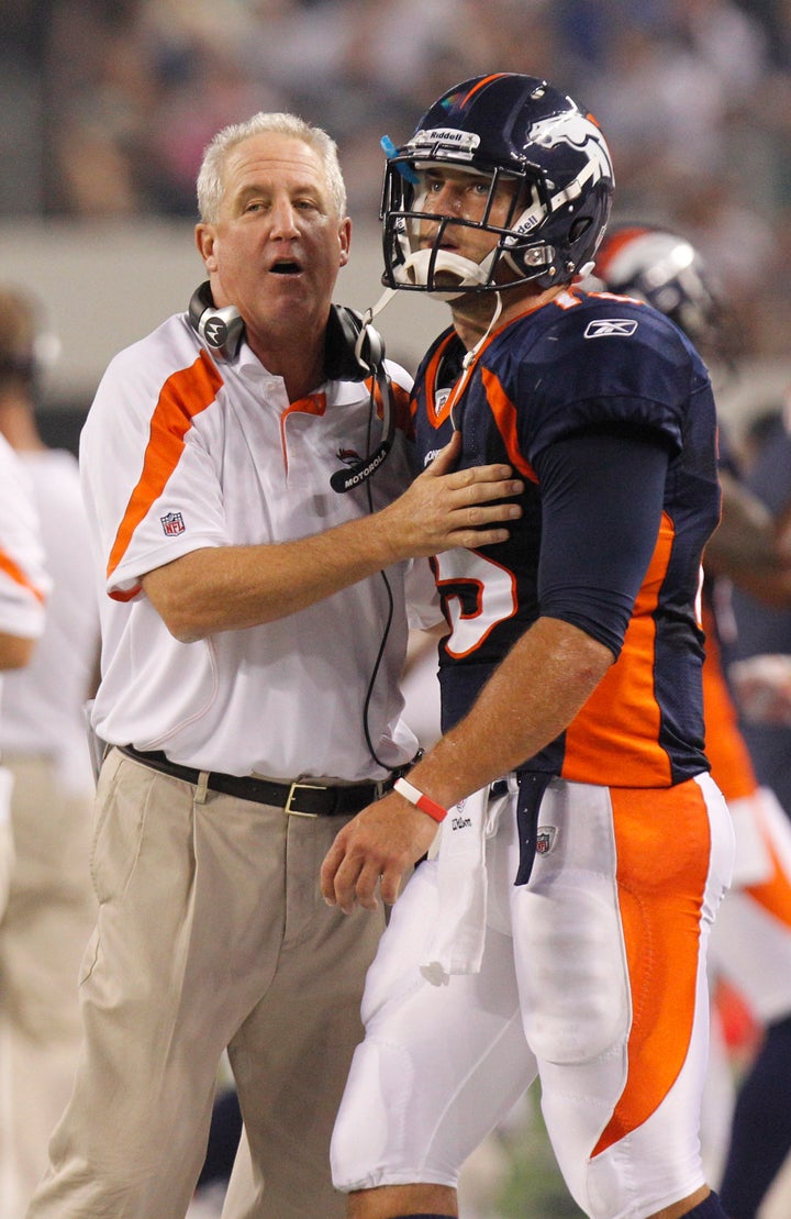 Head coach John Fox talks to Tim Tebow during the second half of