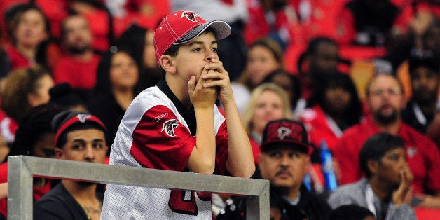 ATLANTA, GA - NOVEMBER 10: A young fan of the Atlanta Falcons watches the action against the Seattle Seahawks at the Georgia