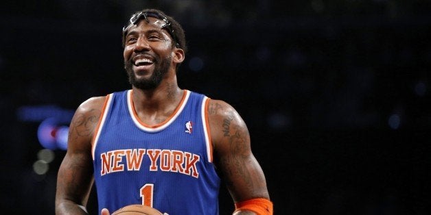 FILE - In this Dec. 5, 2013, file photo, New York Knicks forward Amare Stoudemire smiles before shooting a free throw during the team's NBA basketball game against the Brooklyn Nets in New York. Stoudemire retired Tuesday, July 26, 2016, after signing a contract with the Knicks with much less fanfare than the $100 million deal he inked six years ago to halt the team's downward spiral. "Although my career has taken me to other places around the country, my heart had always remained in the Big Apple," he said in a statement. "Once a Knick, Always a Knick." (AP Photo/Kathy Willens, File)