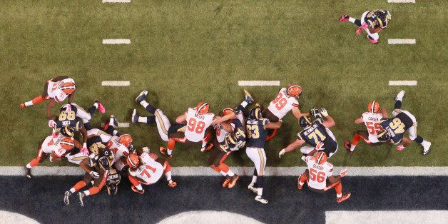 The St. Louis Rams offensive line and tight ends block for running back Todd Gurley, top right, who scored untouched around left end for his first career NFL touchdown during third quarter action on Sunday, Oct. 25, 2015, at Edward Jones Dome in St. Louis. (Chris Lee/St. Louis Post-Dispatch/TNS via Getty Images)