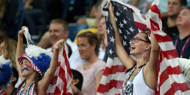 RIO DE JANEIRO, BRAZIL - AUGUST 06: Fans hold up United States flags during the Men's Preliminary Round Group A match between the United States and China on Day 1 of the Rio 2016 Olympic Games at Carioca Arena 1 on August 6, 2016 in Rio de Janeiro, Brazil. (Photo by Elsa/Getty Images)