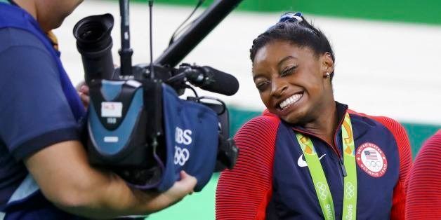 2016 Rio Olympics - Artistic Gymnastics - Victory Ceremony - Women's Individual All-Around Victory Ceremony - Rio Olympic Arena - Rio de Janeiro, Brazil - 11/08/2016. Simone Biles (USA) of USA, wearing her gold medal, reacts at a camera after winning the women's individual all-around final. REUTERS/Mike Blake TPX IMAGES OF THE DAY. FOR EDITORIAL USE ONLY. NOT FOR SALE FOR MARKETING OR ADVERTISING CAMPAIGNS. 