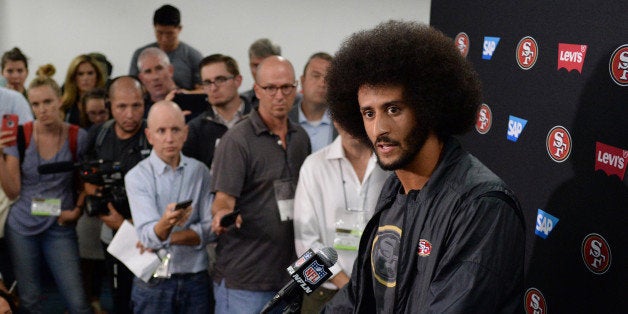 Sep 1, 2016; San Diego, CA, USA; San Francisco 49ers quarterback Colin Kaepernick (right) talks to media after the game against the San Diego Chargers at Qualcomm Stadium. Mandatory Credit: Jake Roth-USA TODAY Sports