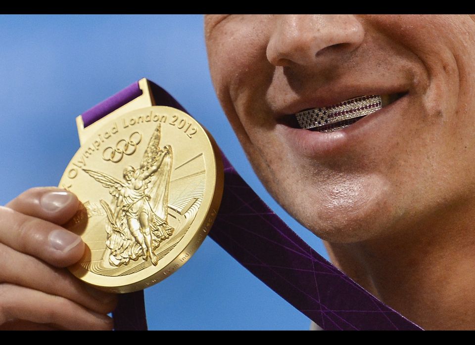 US swimmer Ryan Lochte poses with his de