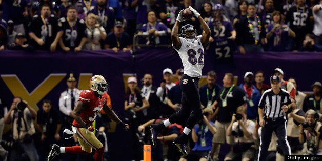 NEW ORLEANS, LA - FEBRUARY 03: Torrey Smith #82 of the Baltimore Ravens makes a reception against Donte Whitner #31 of the S