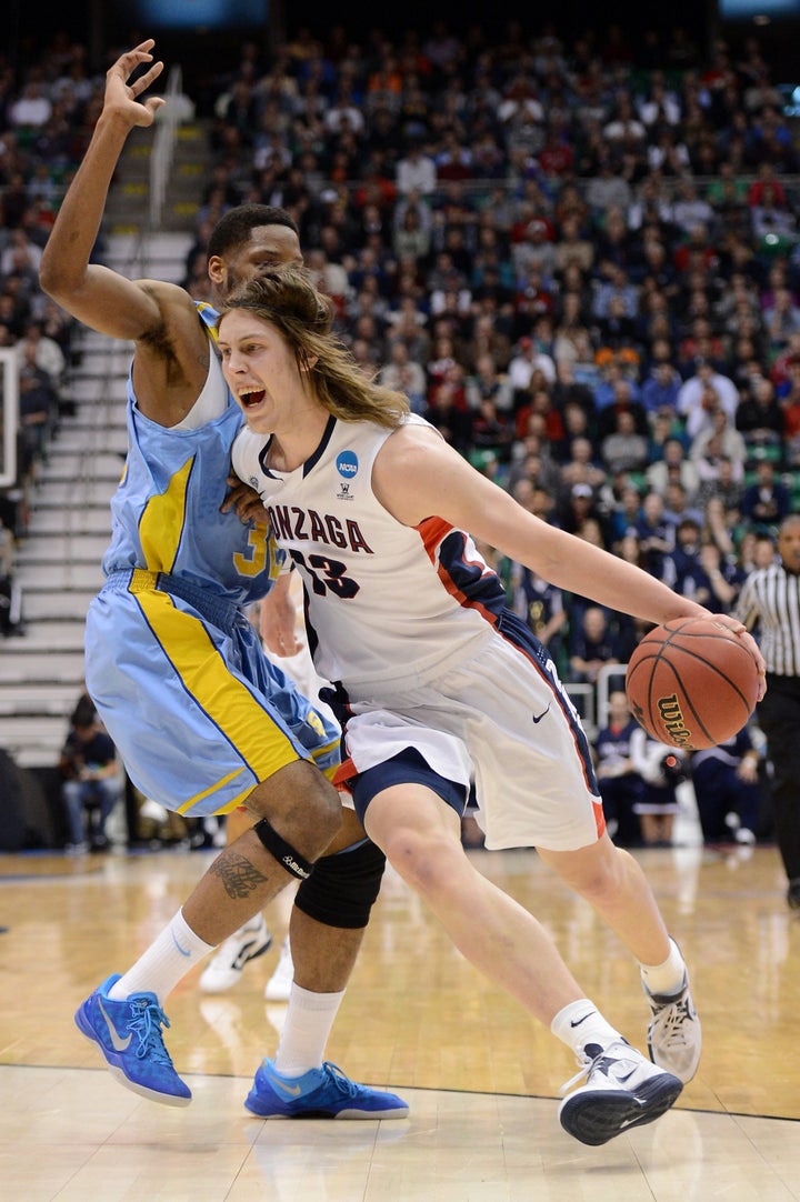 SALT LAKE CITY, UT - MARCH 21: Kelly Olynyk #13 of the Gonzaga Bulldogs with the ball against Brandon Moore #32 of the South