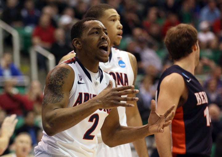 SALT LAKE CITY, UT - MARCH 21: Mark Lyons #2 of the Arizona Wildcats reacts after a drive to the basket in the first half wh