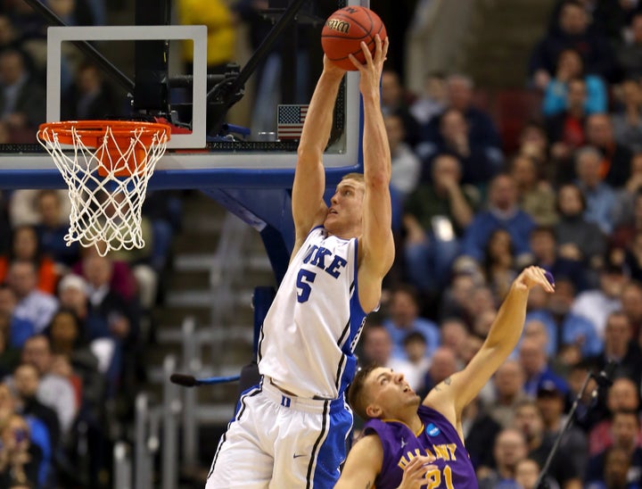 PHILADELPHIA, PA - MARCH 22: Mason Plumlee #5 of the Duke Blue Devils catches a pass for a dunk over Blake Metcalf #21 of th