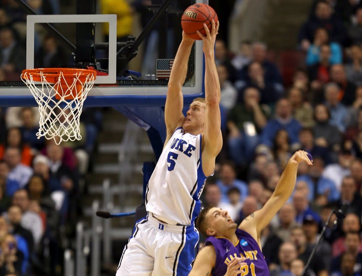 PHILADELPHIA, PA - MARCH 22: Mason Plumlee #5 of the Duke Blue Devils catches a pass for a dunk over Blake Metcalf #21 of the Albany Great Danes in the first half during the second round of the 2013 NCAA Men's Basketball Tournament on March 22, 2013 at Wells Fargo Center in Philadelphia, Pennsylvania. (Photo by Elsa/Getty Images)