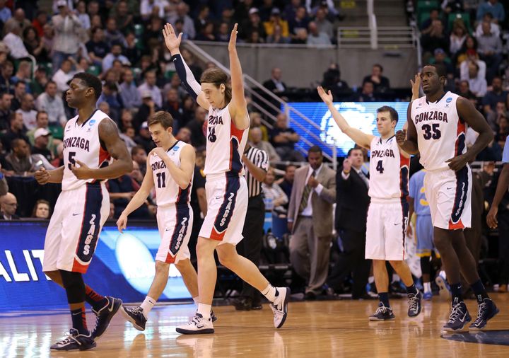 SALT LAKE CITY, UT - MARCH 21: Gary Bell, Jr. #5, David Stockton #11, Kelly Olynyk #13, Kevin Pangos #4 and Sam Dower #35 of the Gonzaga Bulldogs celebrate as they head to the bench late in the second half against the Southern University Jaguars during the second round of the 2013 NCAA Men's Basketball Tournament at EnergySolutions Arena on March 21, 2013 in Salt Lake City, Utah. (Photo by Streeter Lecka/Getty Images)