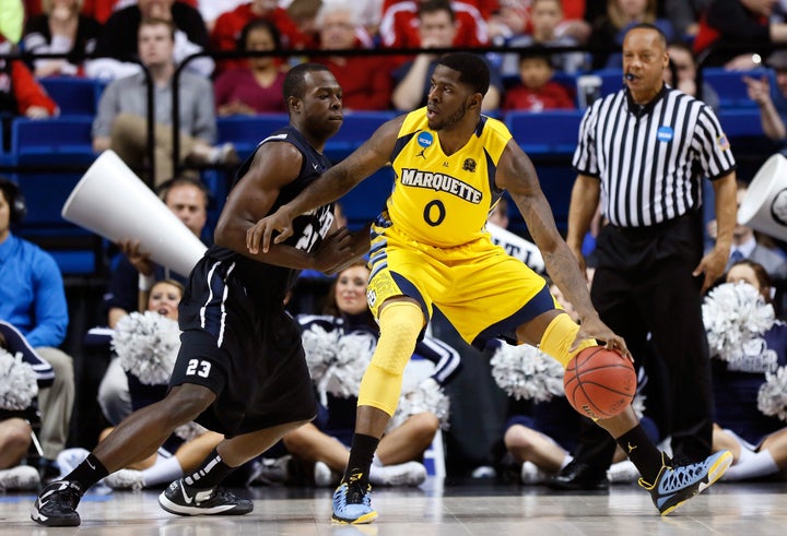 LEXINGTON, KY - MARCH 23: Jamil Wilson #0 of the Marquette Golden Eagles handles the ball against Roosevelt Jones #21 of the