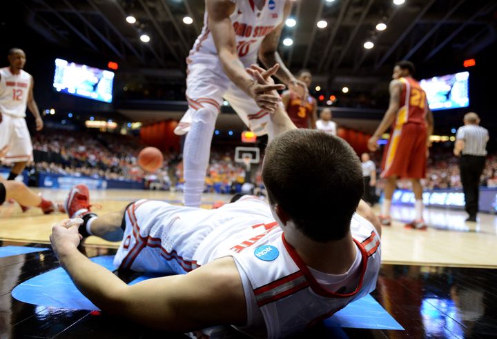 DAYTON, OH - MARCH 24: Aaron Craft #4 of the Ohio State Buckeyes is helped up off the court by LaQuinton Ross #10 after a play against the Iowa State Cyclones in the second half during the third round of the 2013 NCAA Men's Basketball Tournament at UD Arena on March 24, 2013 in Dayton, Ohio. (Photo by Jason Miller/Getty Images)
