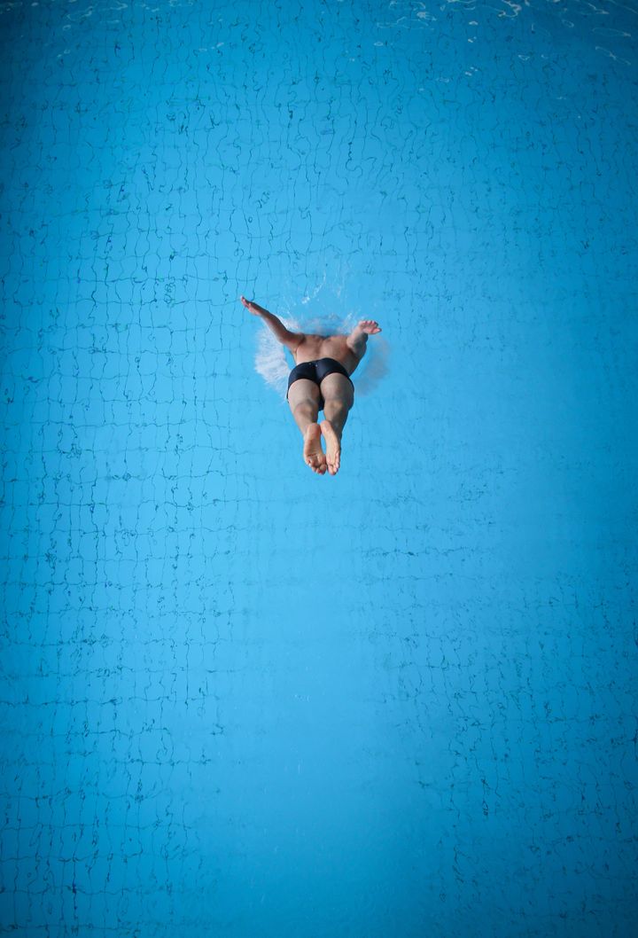 man jumping in pool