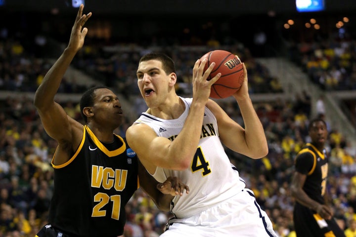 AUBURN HILLS, MI - MARCH 23: Mitch McGary #4 of the Michigan Wolverines drives in the first half against Treveon Graham #21 of the Virginia Commonwealth Rams during the third round of the 2013 NCAA Men's Basketball Tournament at The Palace of Auburn Hills on March 23, 2013 in Auburn Hills, Michigan. (Photo by Jonathan Daniel/Getty Images)