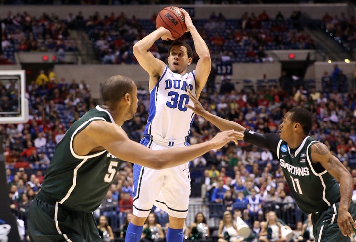 INDIANAPOLIS, IN - MARCH 29: Seth Curry #30 of the Duke Blue Devils attempts a shot over Adreian Payne #5 and Keith Appling