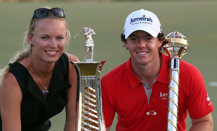 DUBAI, UNITED ARAB EMIRATES - NOVEMBER 25: Caroline Wozniacki of Denmark and Rory McIlroy of Northern Ireland with the DP World Tour Championship and The Race to Dubai trophy on the 18th green during the final roung of the DP World Tour Championship on the Earth Course at Jumeirah Golf Estates on November 25, 2012 in Dubai, United Arab Emirates. (Photo by Ross Kinnaird/Getty Images)