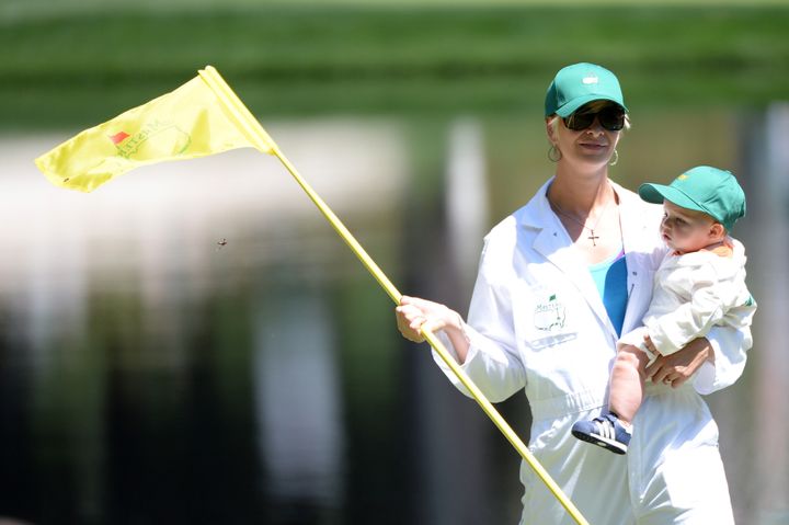 AUGUSTA, GA - APRIL 10: Bubba Watson's wife, Angie Watson, lifts his son, Caleb, during the Par 3 Contest prior to the start of the 2013 Masters Tournament at Augusta National Golf Club on April 10, 2013 in Augusta, Georgia. (Photo by Harry How/Getty Images)