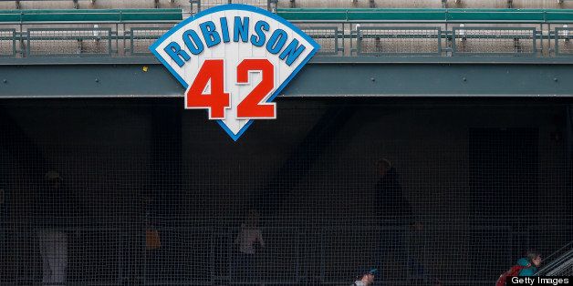 SEATTLE, WA - APRIL 16: Fans enter the park in left field under a sign honoring Jackie Robinson prior to the game between the Seattle Mariners and the Detroit Tigers at Safeco Field on April 16, 2013 in Seattle, Washington. All uniformed team members are wearing jersey number 42 in honor of Jackie Robinson Day. (Photo by Otto Greule Jr/Getty Images)