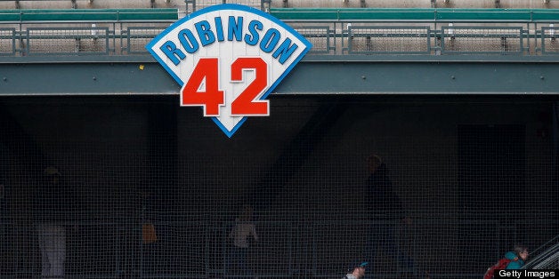 SEATTLE, WA - APRIL 16: Fans enter the park in left field under a sign honoring Jackie Robinson prior to the game between th