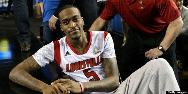ATLANTA, GA - APRIL 08: Injured guard Kevin Ware #5 of the Louisville Cardinals leans on the court as the Cardinals get set to play against the Michigan Wolverines during the 2013 NCAA Men's Final Four Championship at the Georgia Dome on April 8, 2013 in Atlanta, Georgia. (Photo by Streeter Lecka/Getty Images)