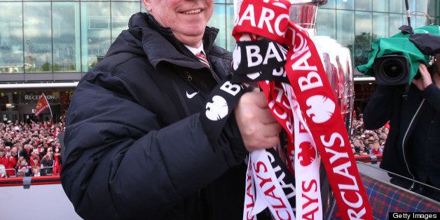 MANCHESTER, ENGLAND - MAY 13: Manager Sir Alex Ferguson of Manchester United poses with the Premier League trophy at the start of the Premier League trophy winners parade on May 13, 2013 in Manchester, England. (Photo by Matthew Peters/Man Utd via Getty Images)