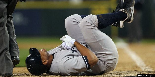 SEATTLE, WA - JULY 24: Alex Rodriguez #13 of the New York Yankees writhes in pain after being hit with a pitch on the arm by starting pitcher Felix Hernandez of the Seattle Mariners at Safeco Field on July 24, 2012 in Seattle, Washington. Rodriguez was removed from the game. (Photo by Otto Greule Jr/Getty Images)