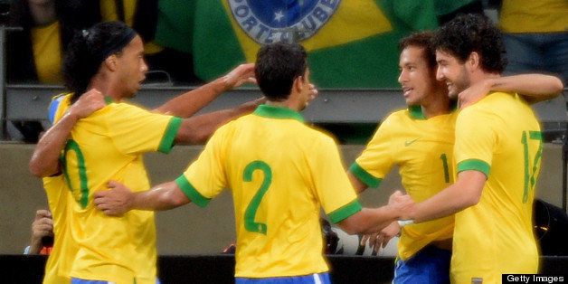 Brazil's Neymar (2-R) celebrates with teammates his second goal against Chile, during their friendly football match at the Mineirao stadium, in Belo Horizonte, Minas Gerais, Brazil, on April 24, 2013. AFP PHOTO /VANDERLEI ALMEIDA (Photo credit should read VANDERLEI ALMEIDA/AFP/Getty Images)