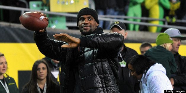 EUGENE, OR - NOVEMBER 19: LeBron James a throws a football on the sidelines before the game between the Oregon Ducks and the USC Trojans at Autzen Stadium on November 19, 2011 in Eugene, Oregon. (Photo by Steve Dykes/Getty Images)