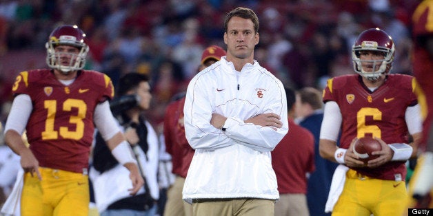 LOS ANGELES, CA - NOVEMBER 24: Head Coach Lane Kiffin of the USC Trojans walks away from Max Wittek #13 and Cody Kessler #6