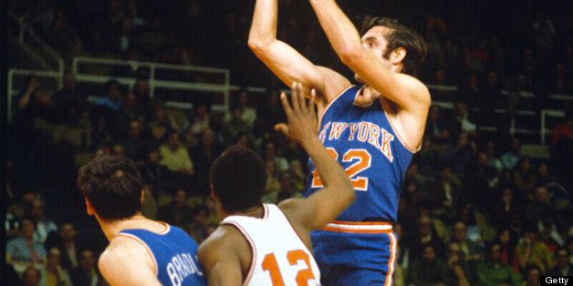 BALTIMORE, MD - CIRCA 1970: Dave DeBusschere #22 of the New York Knicks shoots over Jim Barnes #12 of the Baltimore Bullets circa 1970 at the Baltimore Civic Center in Baltimore, Maryland. DeBusschere played for the Knicks from 1968-74. (Photo by Focus on Sport/Getty Images) 