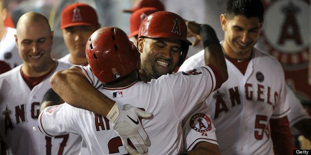ANAHEIM, CA - JUNE 04: Albert Pujols #5 of the Los Angeles Angels of Anaheim celebrates with teammate Erick Aybar #2 after hitting a two run homerun in the eighth inning against the Chicago Cubs at Angel Stadium of Anaheim on June 4, 2013 in Anaheim, California. (Photo by Lisa Blumenfeld/Getty Images)