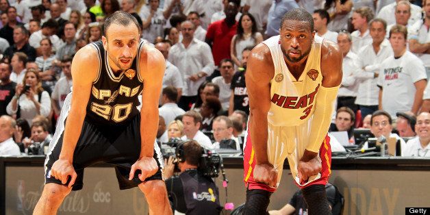 MIAMI, FL - JUNE 6: Manu Ginobili #20 of the San Antonio Spurs and Dwyane Wade #3 of the Miami Heat wait to resume play during Game One of the 2013 NBA Finals on June 6, 2013 at American Airlines Arena in Miami, Florida. NOTE TO USER: User expressly acknowledges and agrees that, by downloading and or using this photograph, User is consenting to the terms and conditions of the Getty Images License Agreement. Mandatory Copyright Notice: Copyright 2013 NBAE (Photo by Issac Baldizon/NBAE via Getty Images)