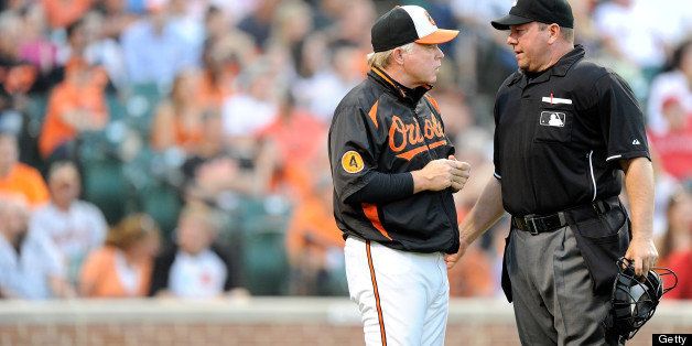 BALTIMORE, MD - JUNE 11: Manager Buck Showalter of the Baltimore Orioles argues a call with home plate umpire Sam Holbrook during the game against the Los Angeles Angels of Anaheim at Oriole Park at Camden Yards on June 11, 2013 in Baltimore, Maryland. (Photo by G Fiume/Getty Images)