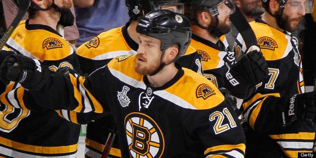 BOSTON, MA - JUNE 19: Andrew Ference #21 of the Boston Bruins celebrates a goal against the Chicago Blackhawks in Game Four