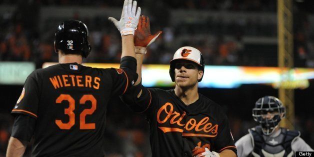 Baltimore Orioles' Matt Wieters, left, congratulates Chris Davis on his homer against the New York Yankees at Oriole Park at Camden Yards in Baltimore, Maryland, Sunday, June 30, 2013. (Algerina Perna/Baltimore Sun/MCT via Getty Images)