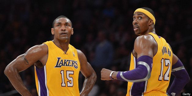 LOS ANGELES, CA - JANUARY 15: Dwight Howard #12 and Metta World Peace #15 of the Los Angeles Lakers look back during a 104-88 win over the Milwaukee Bucks at Staples Center on January 15, 2013 in Los Angeles, California. NOTE TO USER: User expressly acknowledges and agrees that, by downloading and or using this photograph, User is consenting to the terms and conditions of the Getty Images License Agreement. (Photo by Harry How/Getty Images) 