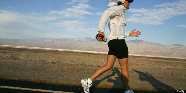 Death Valley, UNITED STATES: Adam Bookspan, 40, of Florida, a professional Musician, sets his pace in the first miles of the Kiehl Badwater Ultramarathon 24 July, 2006, in Death Valley, California. This foot race covers 135 miles (217kms) non-stop from Badwater, the lowest elevation in the Western Hemisphere at 282 feet (85.5 meters) below sea level, to Mt. Whitney Portals at 8,360 feet (2,533 meters) above sea level. Temperature in Death Valley hit 126F (52C) and three mountain ranges are crossed, making this one of the most demanding and extremem running races in the world. AFP PHOTO/ROBYN BECK (Photo credit should read ROBYN BECK/AFP/Getty Images)