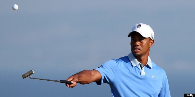 Tiger Woods of the USA walks across the 11th green during the last day of practice ahead of the 2013 British Open Golf Championship at Muirfield golf course at Gullane in Scotland on July 17, 2013 . AFP PHOTOADRIAN DENNIS (Photo credit should read ADRIAN DENNIS/AFP/Getty Images)