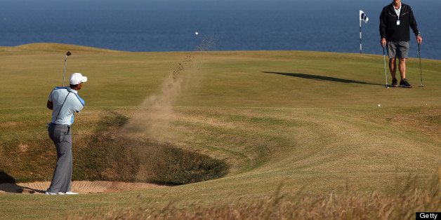 Tiger Woods of the USA plays a shot from a bunker onto the 11th green during the last day of practice ahead of the 2013 British Open Golf Championship at Muirfield golf course at Gullane in Scotland on July 17, 2013 . AFP PHOTOADRIAN DENNIS (Photo credit should read ADRIAN DENNIS/AFP/Getty Images)