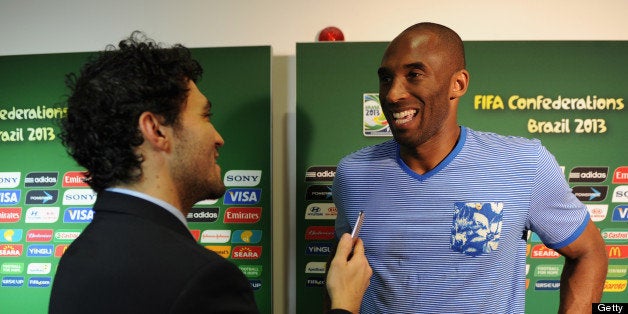 SALVADOR, BRAZIL - JUNE 22: LA Lakers basketball star Kobe Bryant is interviewed prior to the FIFA Confederations Cup Brazil 2013 Group A match between Italy and Brazil at Estadio Octavio Mangabeira (Arena Fonte Nova Salvador) on June 22, 2013 in Salvador, Brazil. (Photo by Buda Mendes - FIFA/FIFA via Getty Images)