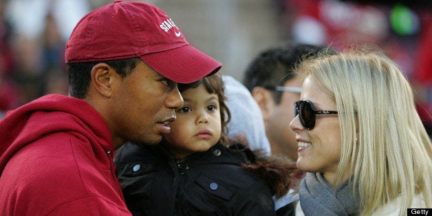 PALO ALTO, CA - NOVEMBER 21: Honorary Standford Cardinal captain Tiger Woods holds his daugher, Sam, and speaks to his wife,