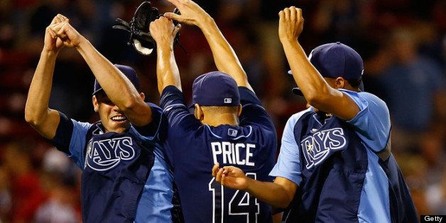 BOSTON, MA - JULY 24: David Price #14 of the Tampa Bay Rays celebrates with teammates following his complete game win against the Boston Red Sox in the 9th inning during the game on July 24, 2013 at Fenway Park in Boston, Massachusetts. (Photo by Jared Wickerham/Getty Images)