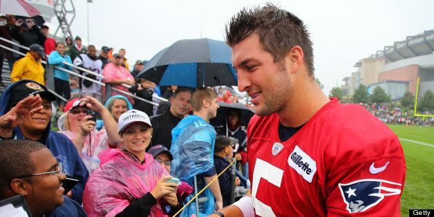 FOXBOROUGH, MA - JULY 26: Patriots quarterback Tim Tebow signs autographs at the end of the camp. The New England Patriots held their first day of training camp at the practice field at Gillette Stadium. (Photo by John Tlumacki/The Boston Globe via Getty Images)