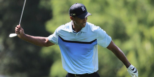 ROCHESTER, NY - AUGUST 08: Tiger Woods of the United States reacts to a poor shot on the fourth hole during the first round